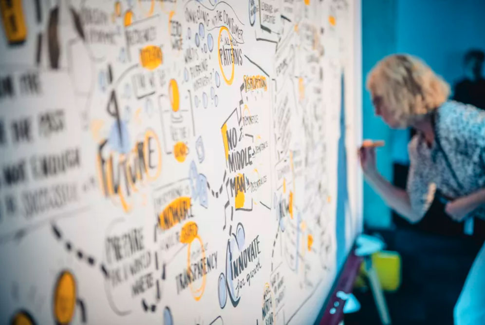 A graphic recorder drawing live at an event